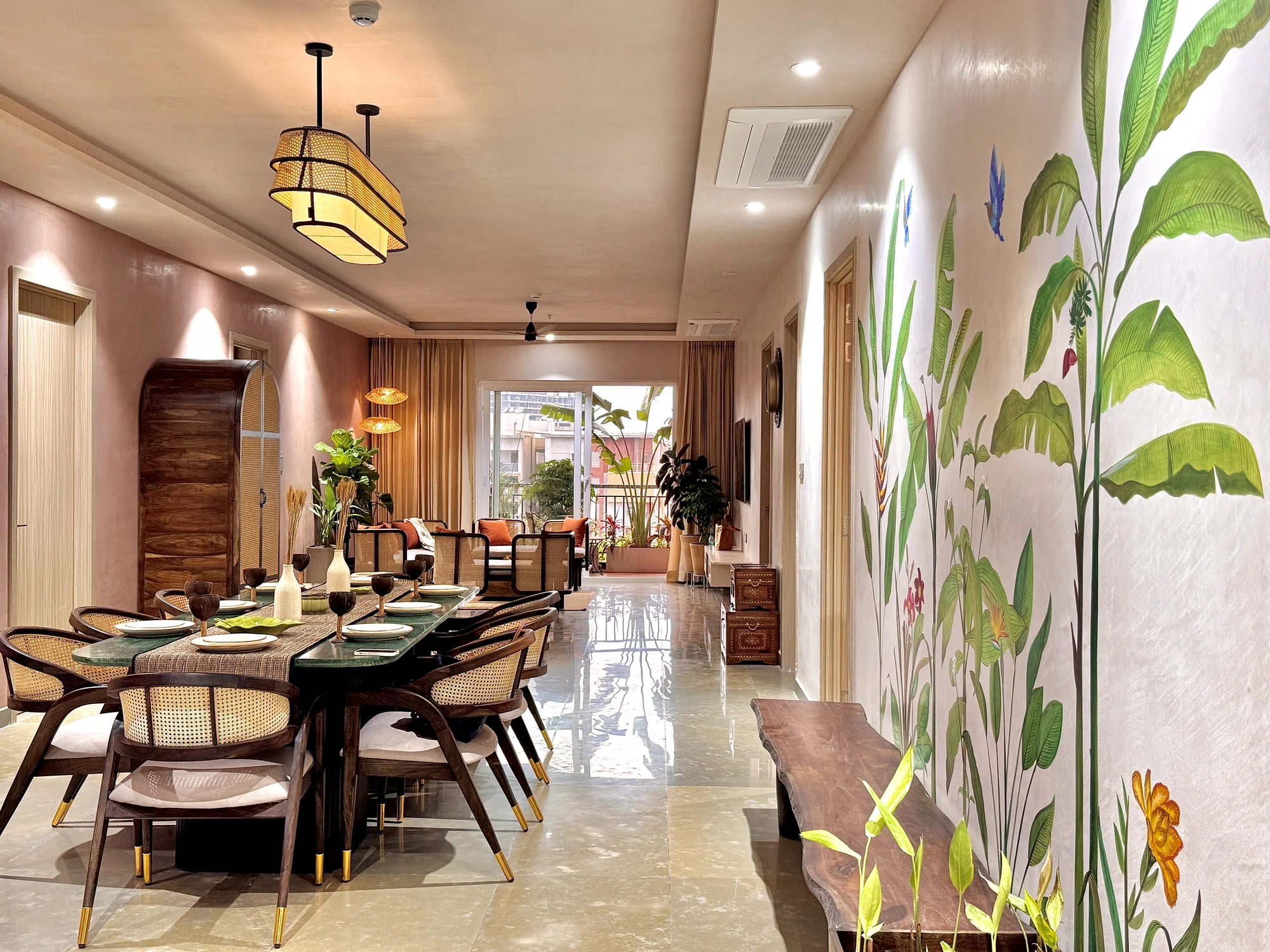 Contemporary dining area with warm finishes, a timber table and a botanical feature wall